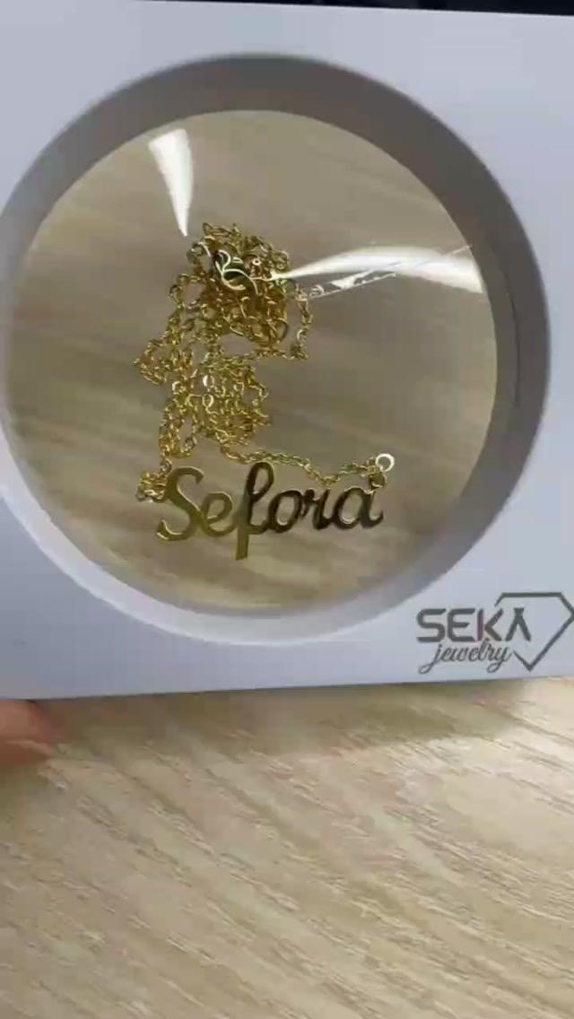 Gold script name necklace in round gift display