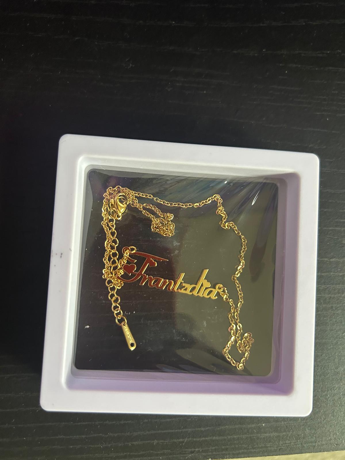 Gold name necklace with heart accent in a gift box